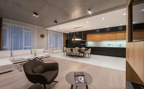Corporate apartment in Bogotá featuring a minimalist design, a modern open-concept kitchen, and a spacious, luxurious living room.