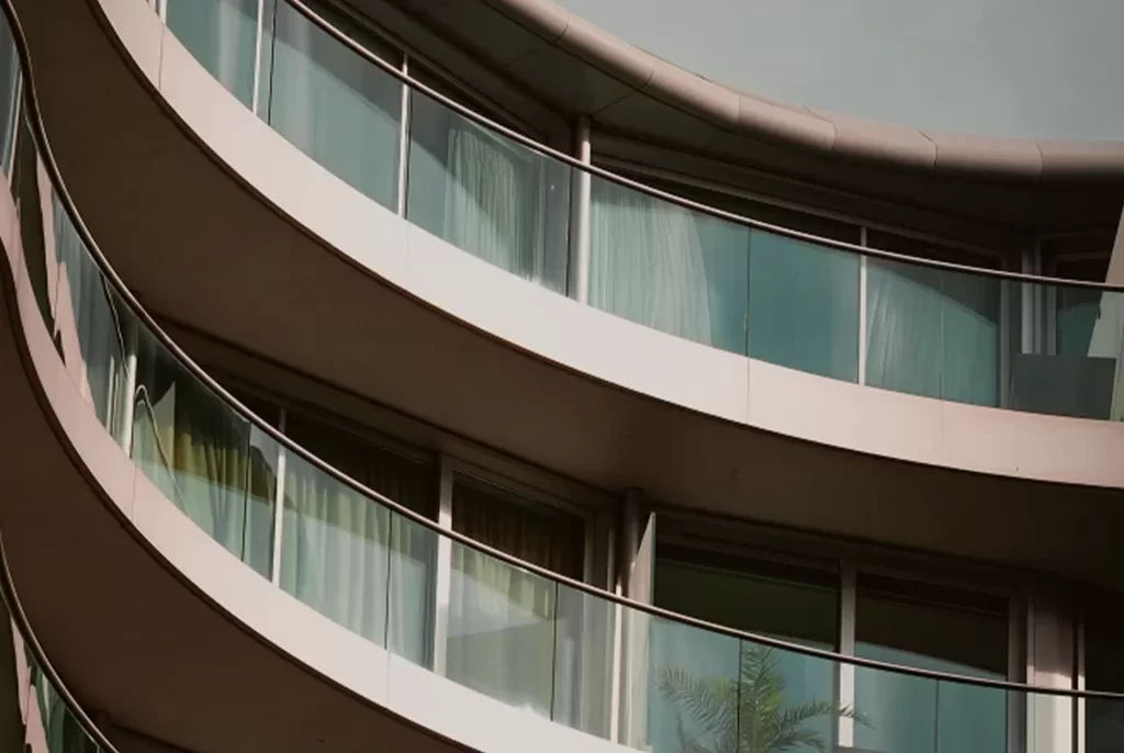 Fachada curva con balcones de vidrio en edificio residencial de lujo en zona Parque 93, apartamentos VEZRA Bogotá.