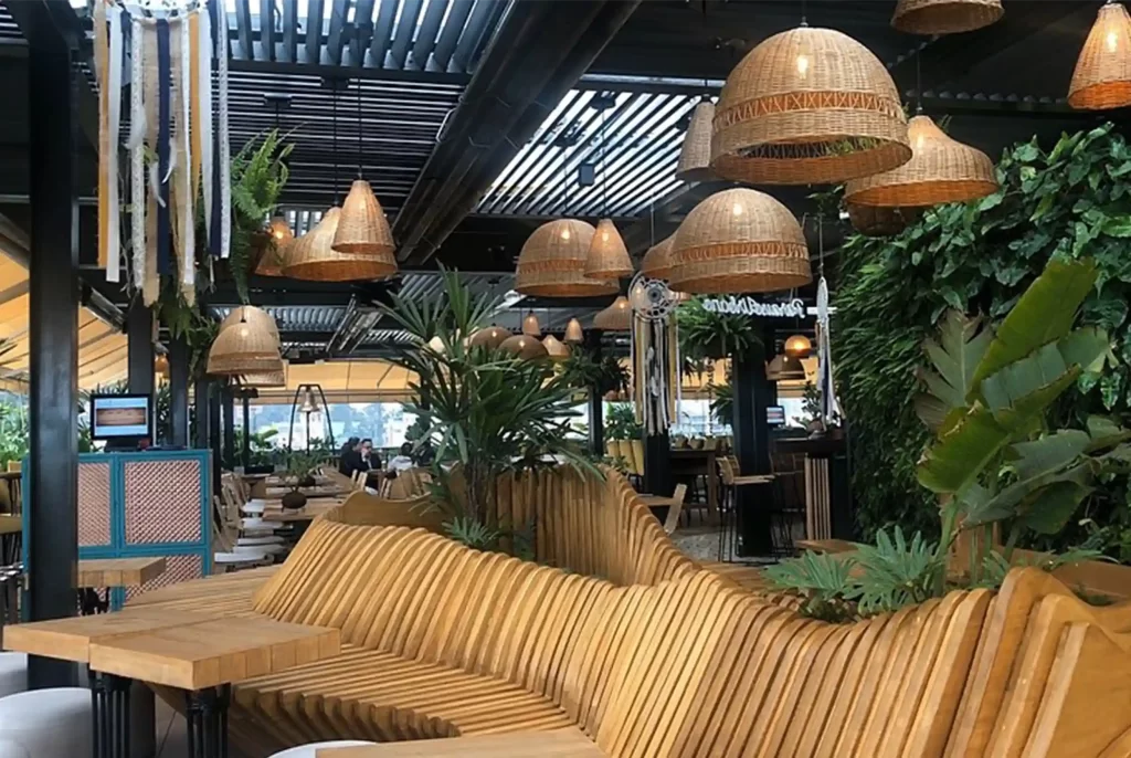 Tropical restaurant with wooden bench and lamps wicker in the area of Park 93, week-end luxury near apartments VEZRA Bogota